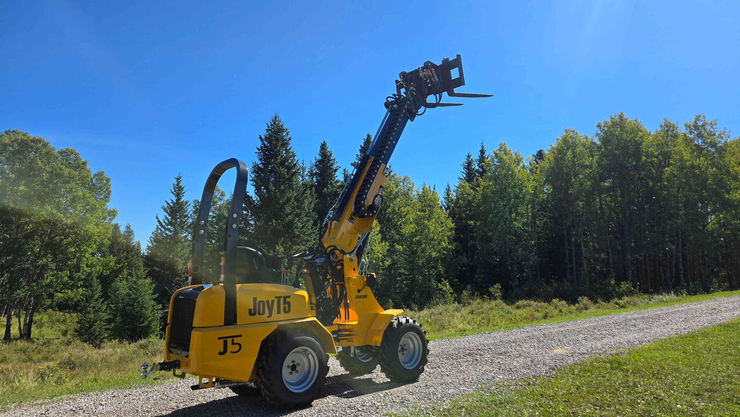 JT5WL800 compact wheel loader performing telescopic lift operation with forklift attachment for construction and landscaping in Canada