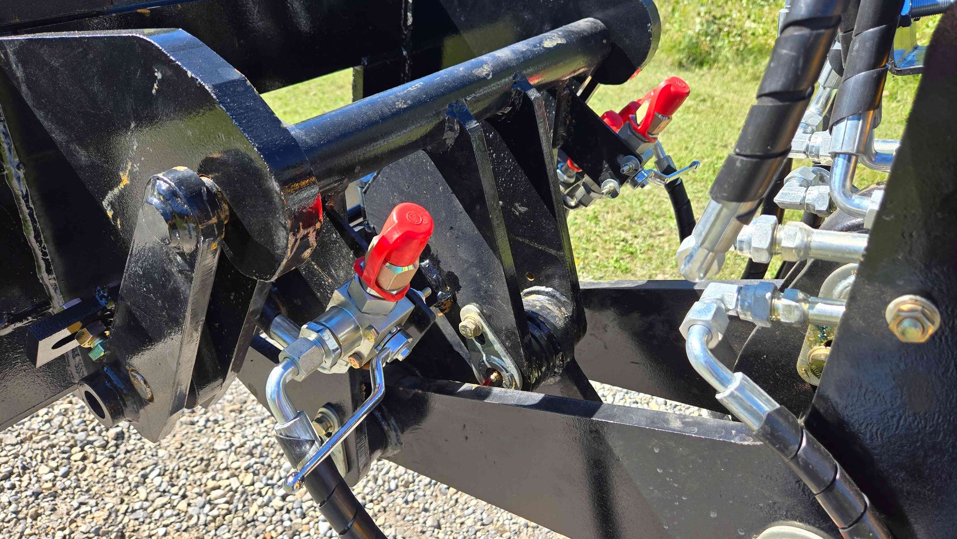 Closeup view of JT5WL800 loader hydraulic valves, quick couplers and heavy duty hoses for attachment control