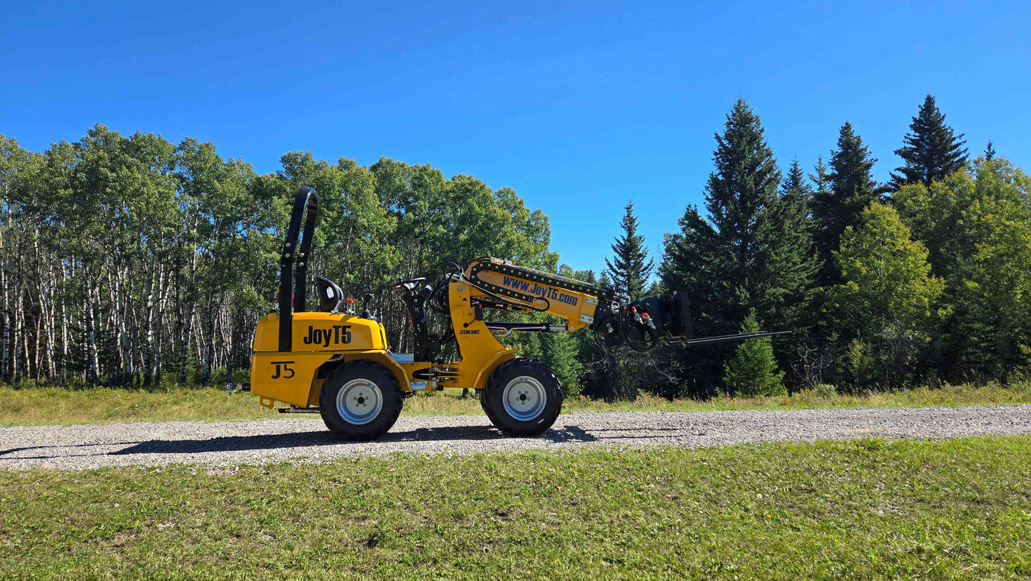 JT5WL800 mini wheel loader 800kg 1750 lbs side view with extended boom on gravel road and trees in background