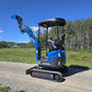 Rippa R15 mini excavator for sale side view with raised bucket on gravel road