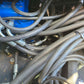 Close up view of multiple hydraulic hoses and metal connectors inside a mini excavator system in Canada for JoyT5