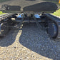 Undercarriage view of rippa r15 mini excavator for sale with hydraulic lines and track motors on gravel ground