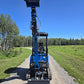 Front view of rippa r15 mini excavator for sale with raised arm and bucket on gravel road
