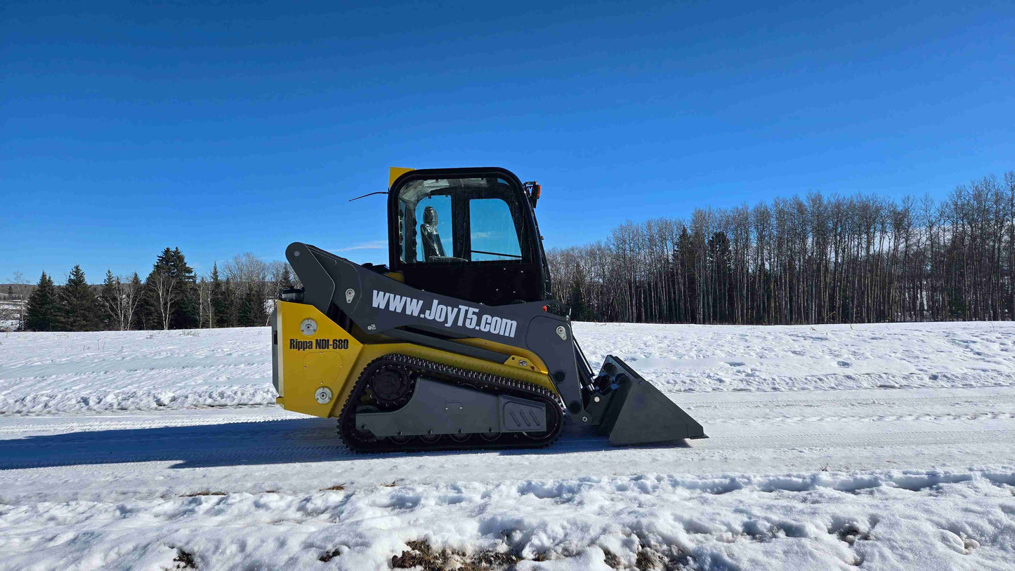 Rippa NDI680 skid steer 74 HP full side profile on snow road showing compact tracked loader for construction landscaping and farming use in Canada by JoyT5