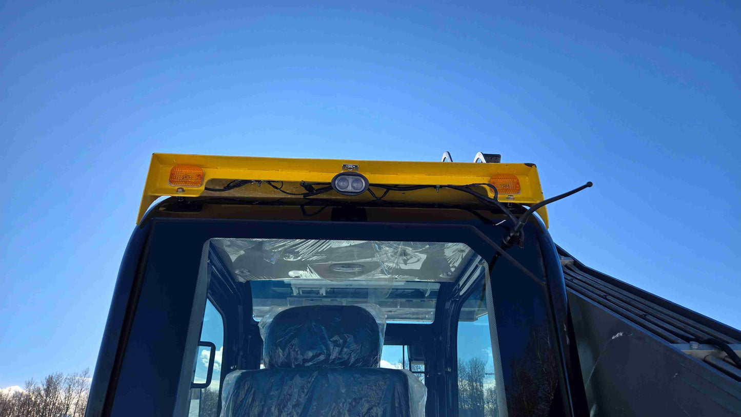 Front roof view of Rippa NDI680 skid steer cabin showing LED work light and amber warning lights for safe operation in construction landscaping and farming projects across Canada by JoyT5