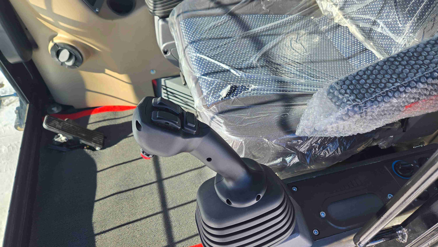 close up view of control joystick and operator seat inside rippa NDI680 skid steer 74 HP compact tracked loader designed for construction in Canada

