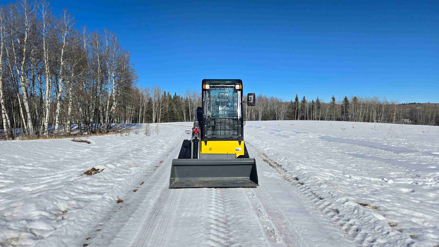rippa NDI680 skid steer 74 HP front view compact tracked loader with bucket on snowy road for construction and snow clearing in Canada

