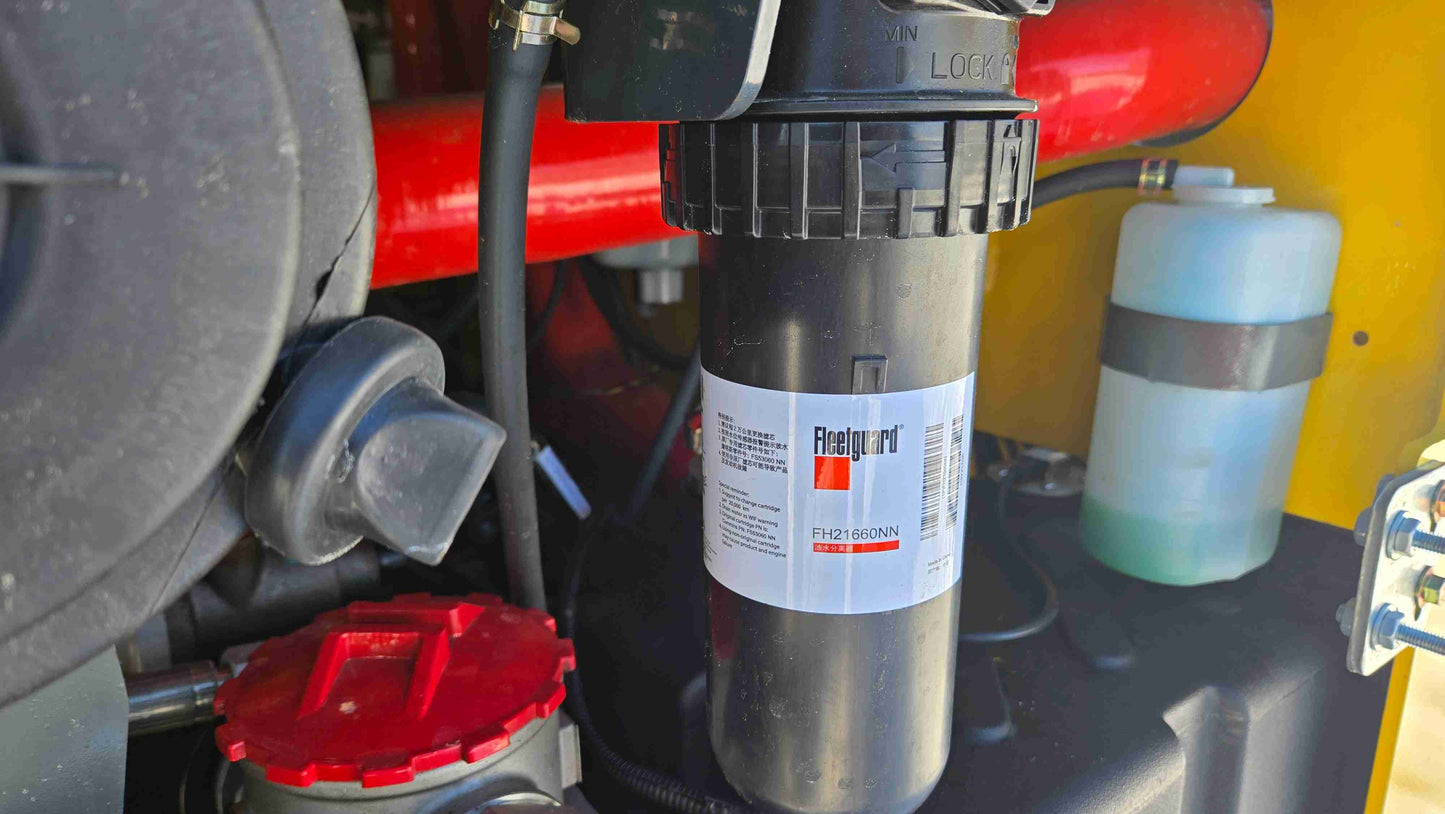 Close up view of Rippa NDI680 skid steer engine fuel and hydraulic filter system showing Fleetguard filter for 74 HP Cummins machine used in heavy duty construction landscaping and farming work across Canada by JoyT5