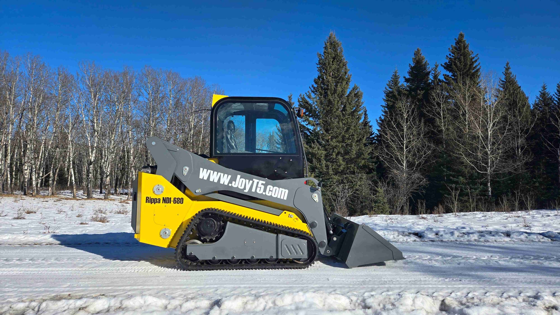 rippa NDI680 skid steer 74 HP heavy duty compact tracked loader with bucket attachment on snowy ground in Canada



