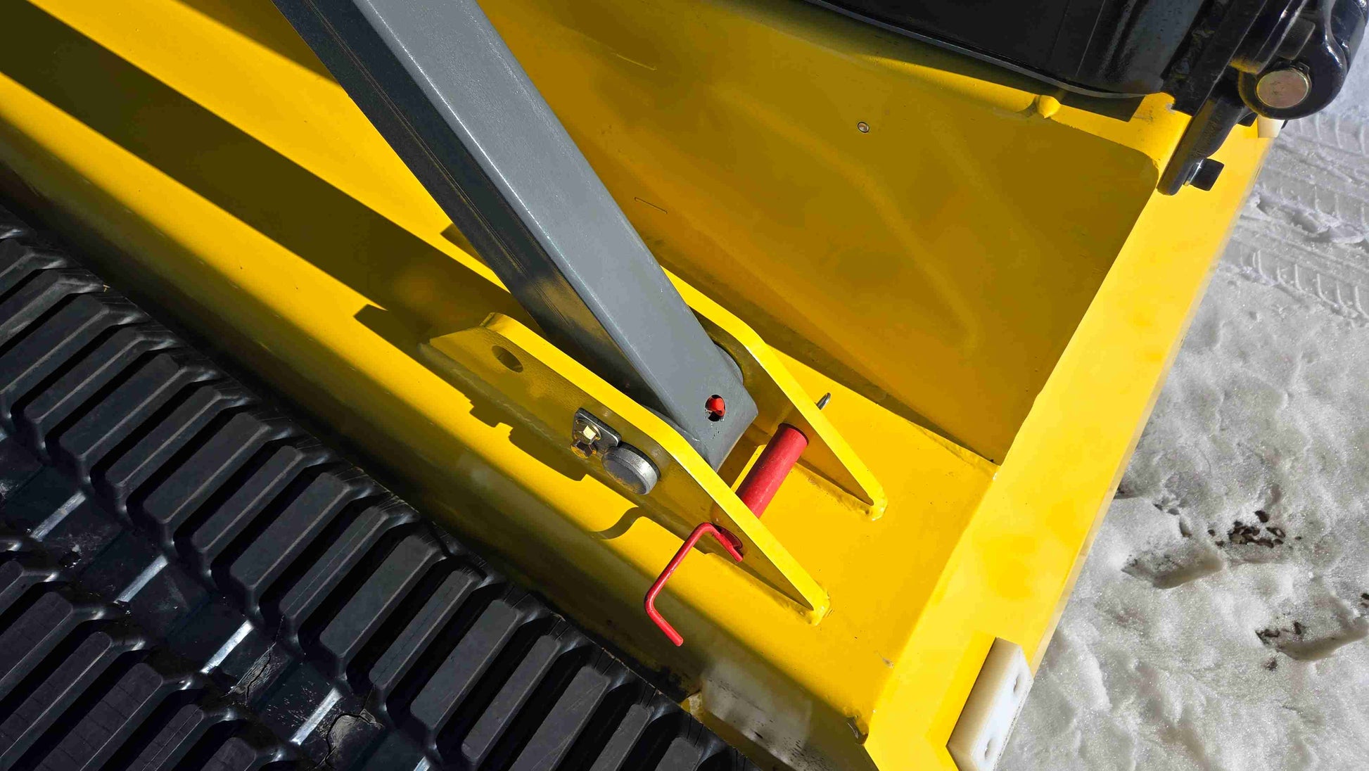Close-up of the loader arm pivot and safety lock mechanism on the Rippa NDI680 skid steer loader | JoyT5