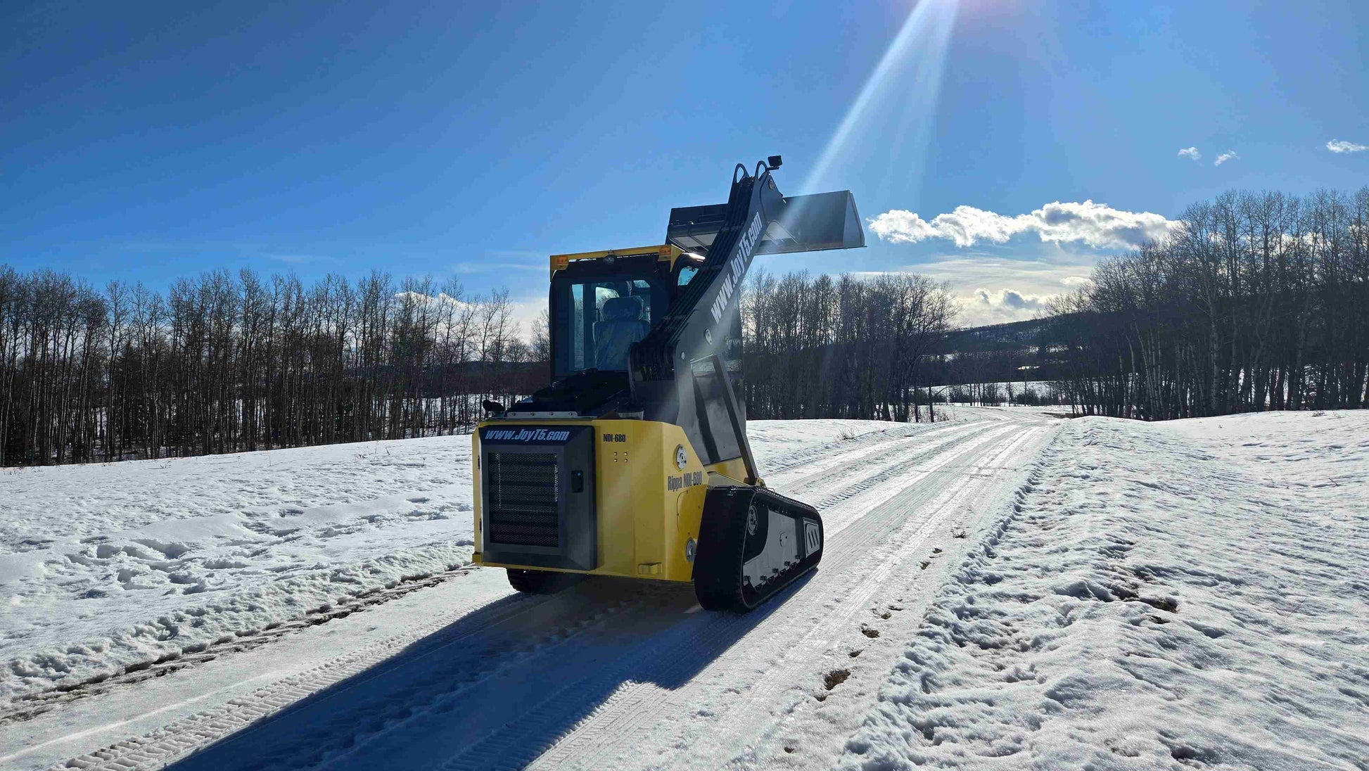 Rippa NDI680 skid steer loader rear view with raised bucket, compact tracked loader for snow clearing in Canada | JoyT5