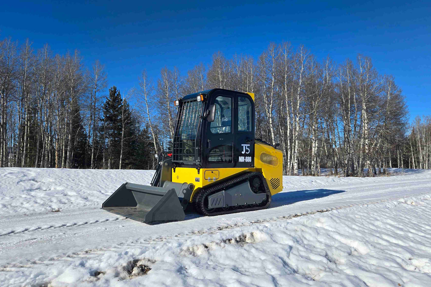 rippa NDI680 skid steer 74 HP working on snow covered ground construction and landscaping loader in Canada

