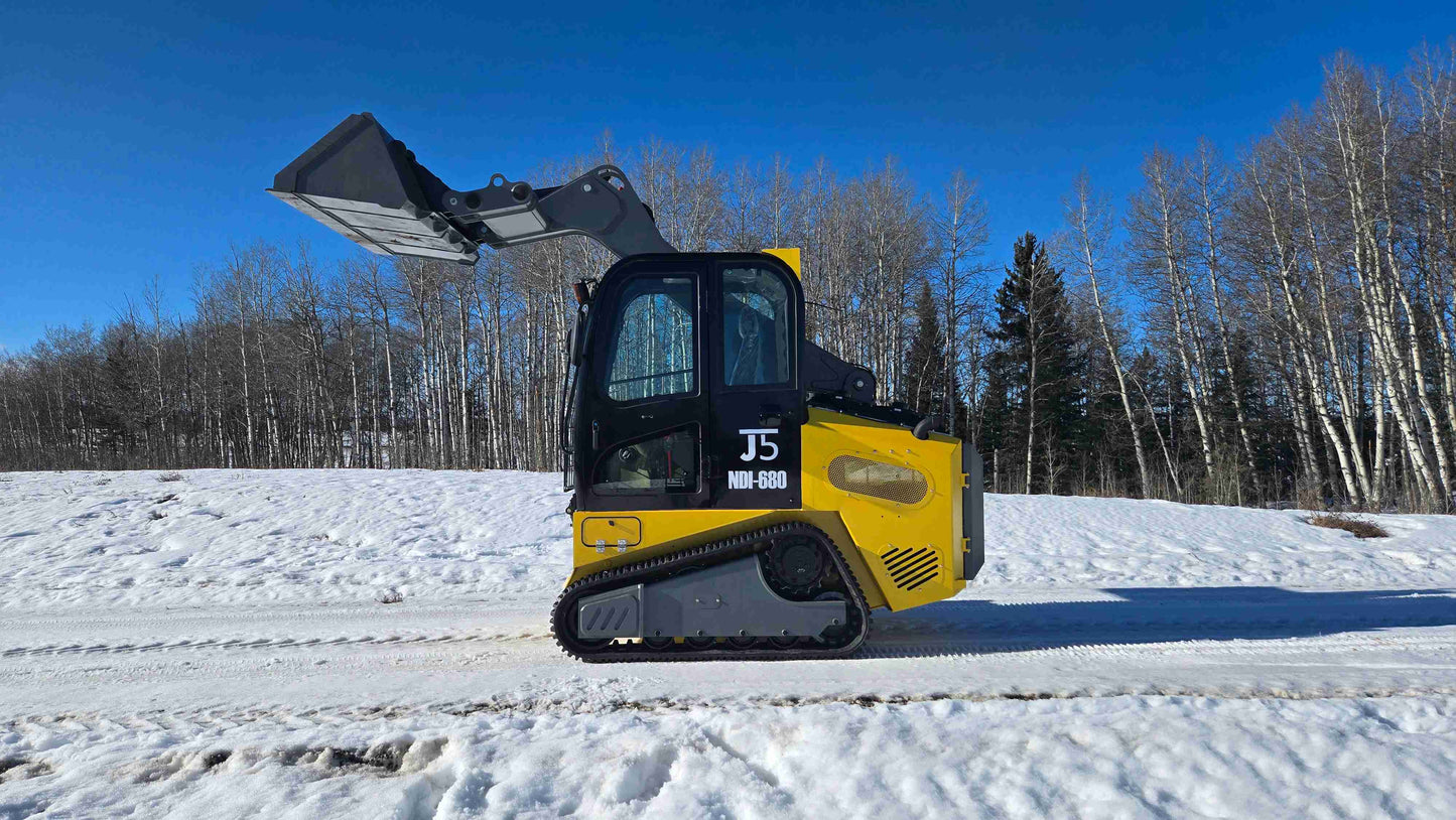 Rippa NDI680 skid steer with raised bucket shown from side view on snow road for lifting and material handling work in Canada with JoyT5