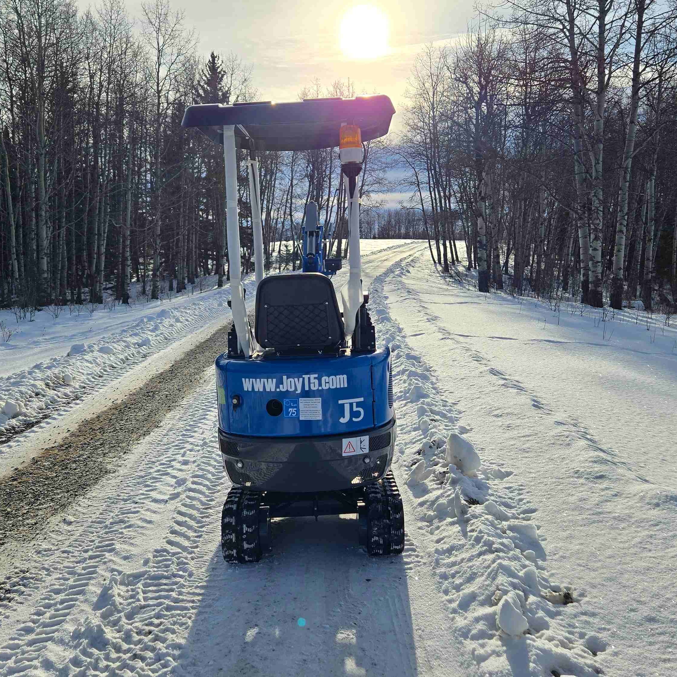 Rear view of Rippa R10 1 ton mini excavator for sale in Canada from JoyT5 on a snowy road showing a compact excavator for tight spaces and landscaping projects