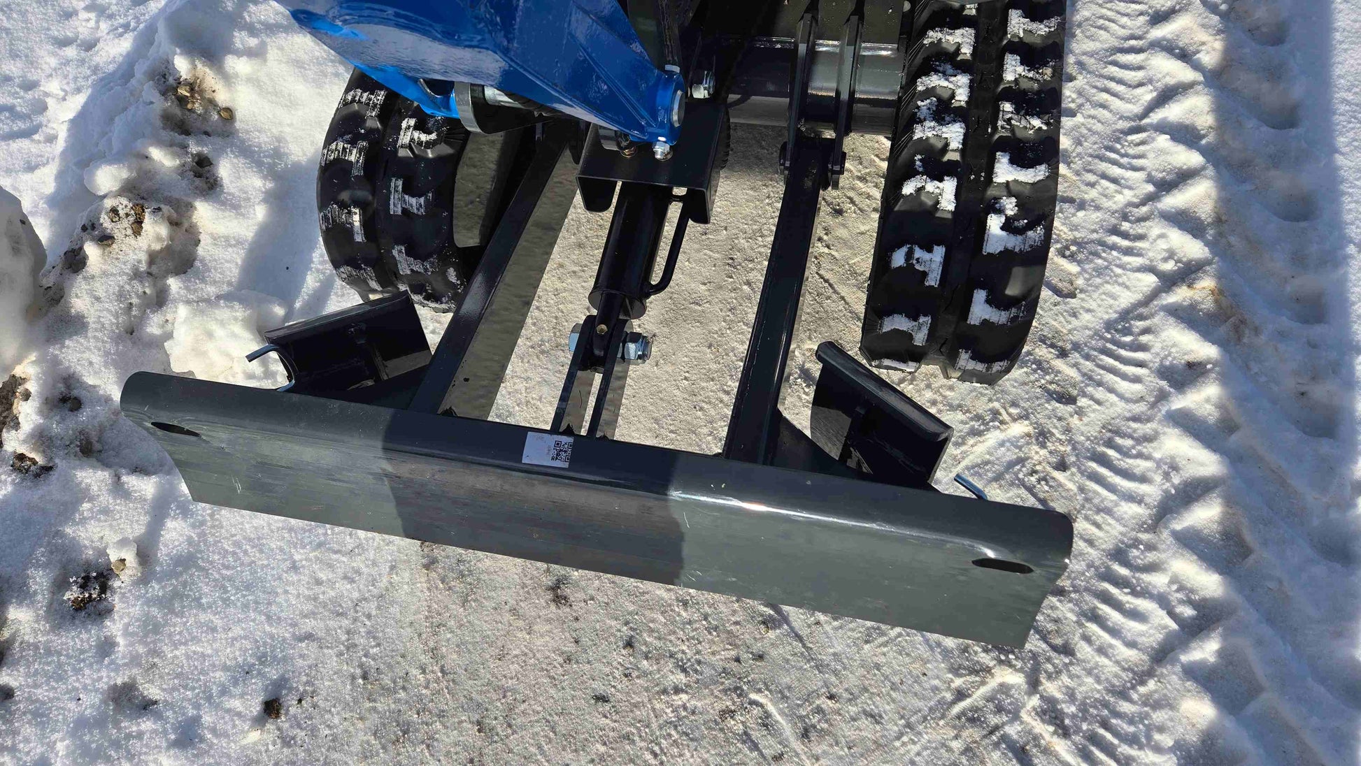 Rippa R10 1 ton mini excavator front dozer blade close up working in snow in Canada with JoyT5 dealer support for compact construction and landscaping projects