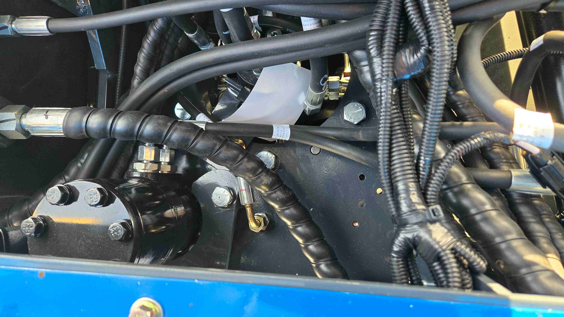 Close up view of hydraulic hoses and fittings on the Rippa R10 1 Ton Mini Excavator for Sale in Canada from JoyT5 showing strong build for small excavator work and tight space construction projects
