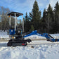 Rippa R10 mini excavator working in the snow on a rural road in Canada with the arm extended showing compact digging capability from JoyT5 for landscaping and small construction projects