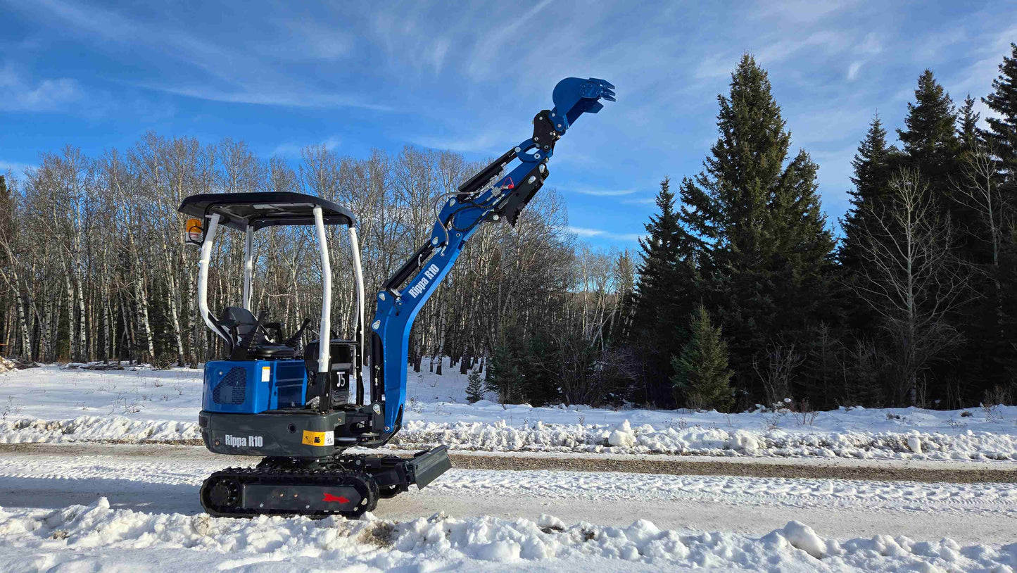 JoyT5 Rippa R10 mini excavator in Canada on snowy road, powerful compact digger for small construction and landscaping projects.