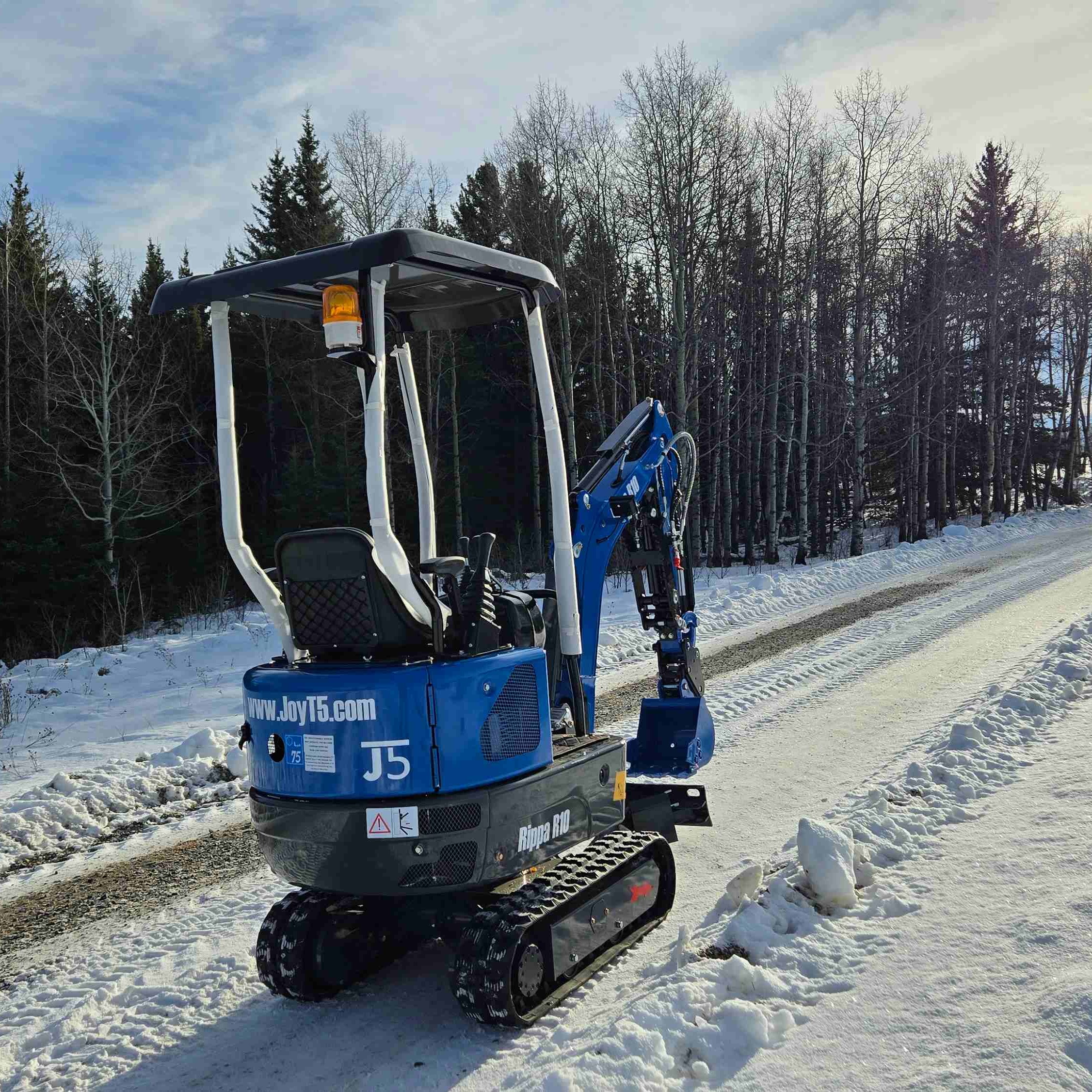 Rippa R10 mini excavator working on a snowy road in Canada with JoyT5 support for small construction and landscaping projects