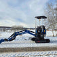 Rippa R10 Mini Excavator with long arm extended on snowy rural road