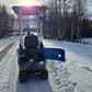Rear view of Rippa R10 mini excavator with open engine compartment on a snowy road in Canada, compact construction digger by JoyT5 for maintenance and performance.