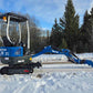 Side view of Rippa R10 mini excavator on snow in Canada, compact and efficient construction digger by JoyT5 for small building and landscaping jobs.