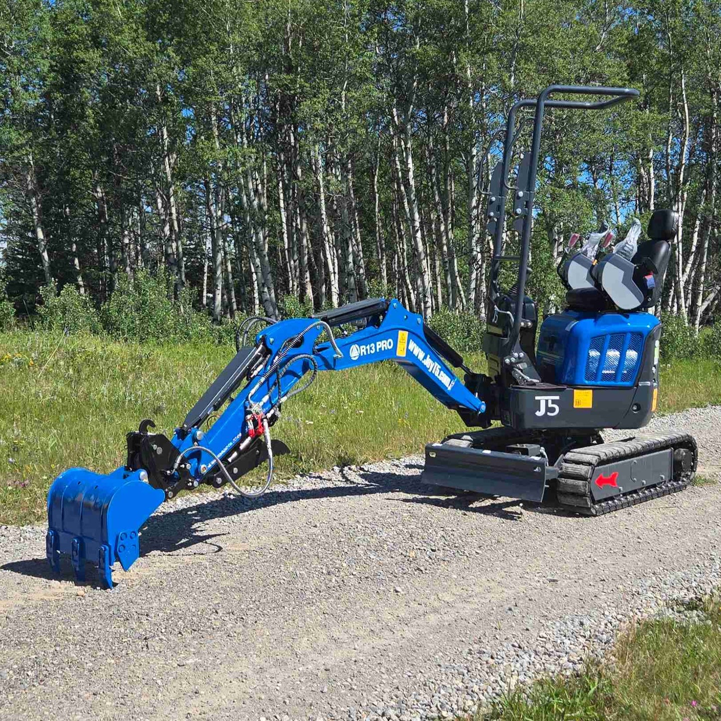 Rippa R13 1.3 ton mini excavator digging position with bucket on gravel surface | Compact mini excavator for construction and landscaping work in Canada with JoyT5 support