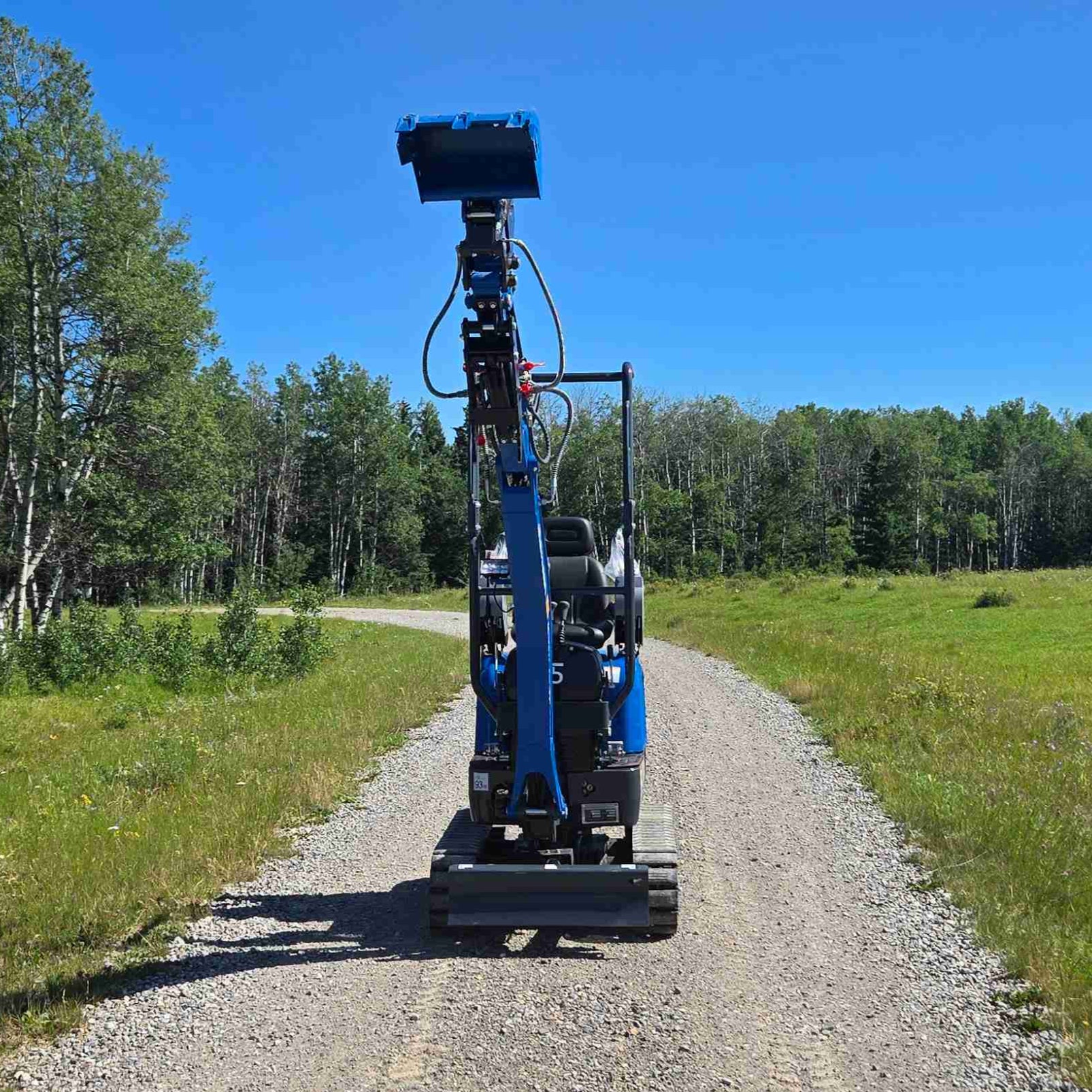 Rippa R13 1.3 ton mini excavator for sale in Canada | Compact mini excavator front view with raised bucket for construction and landscaping supported by JoyT5