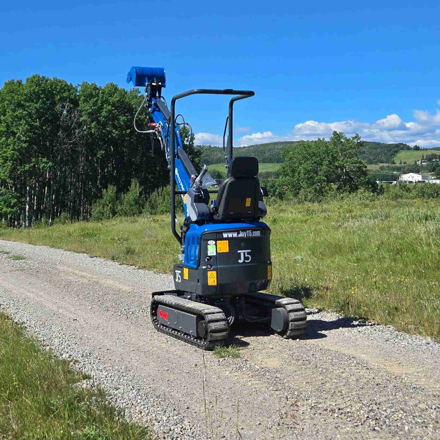 Rippa R13 1.3 ton mini excavator for sale in Canada | Compact mini excavator rear angled view with raised boom for construction and landscaping supported by JoyT5
