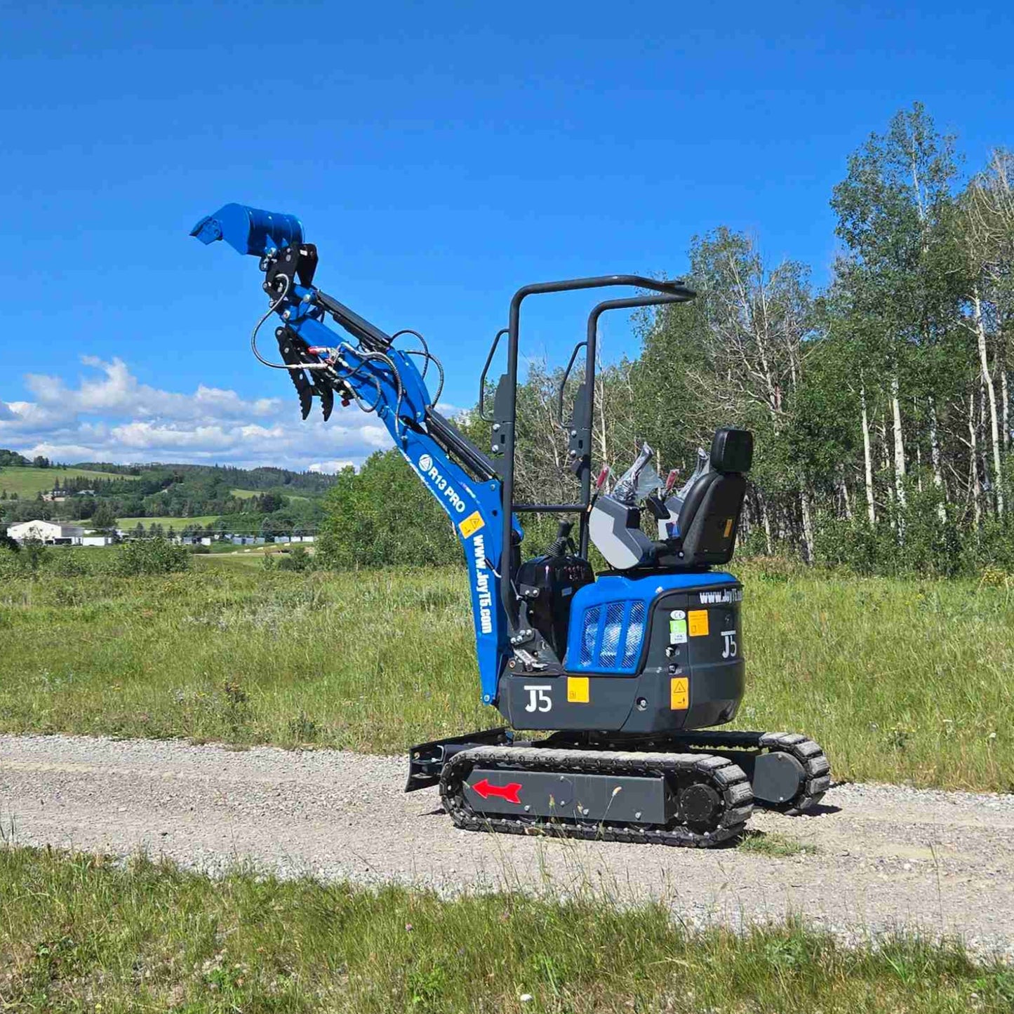 Rippa R13 1.3 ton mini excavator for sale in Canada | Compact mini excavator side view with raised arm for construction and landscaping supported by JoyT5
