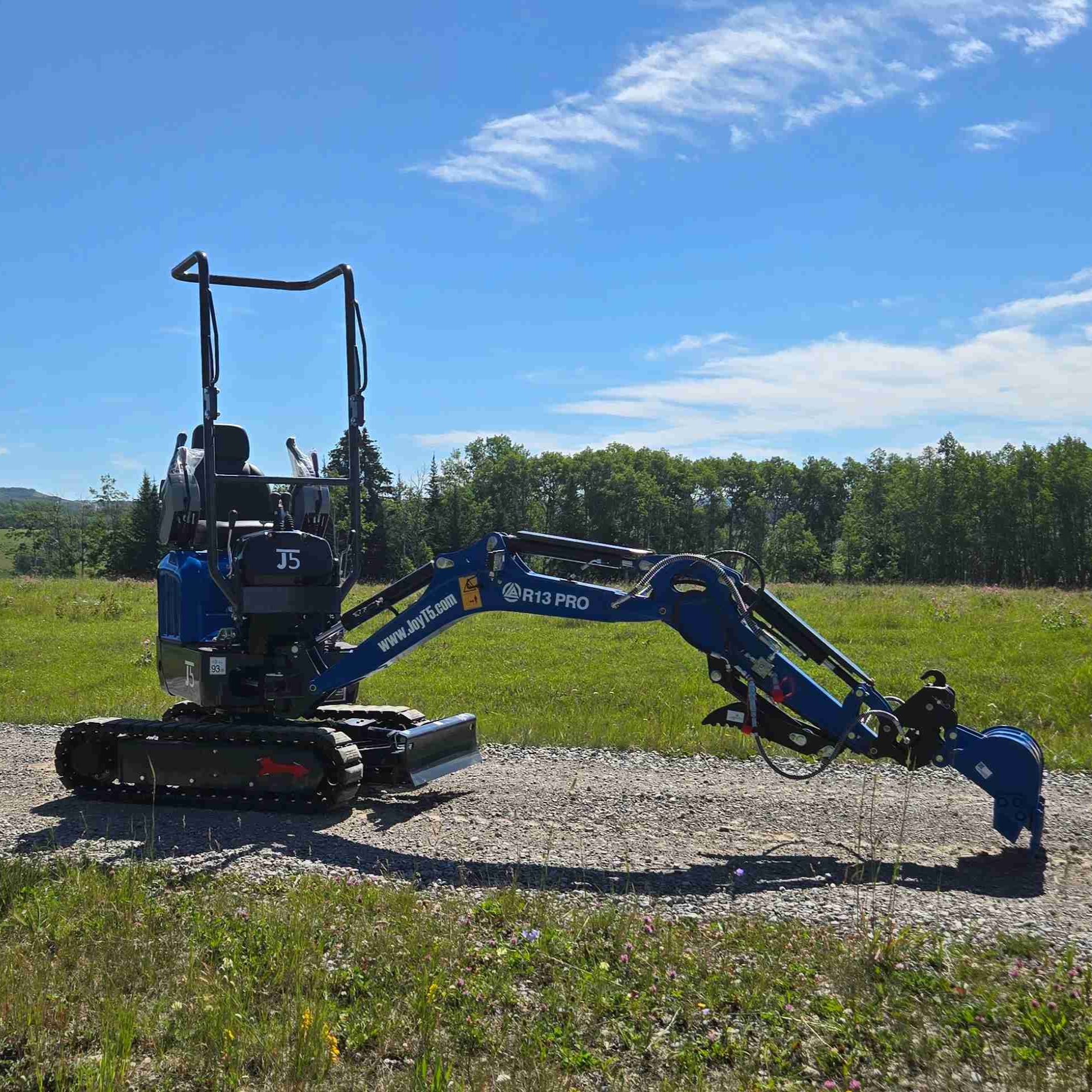 Full side view of Rippa R13 1.3 ton mini excavator with fully extended digging arm on gravel path | Compact mini excavator for construction, landscaping, and property work in Canada with JoyT5 support