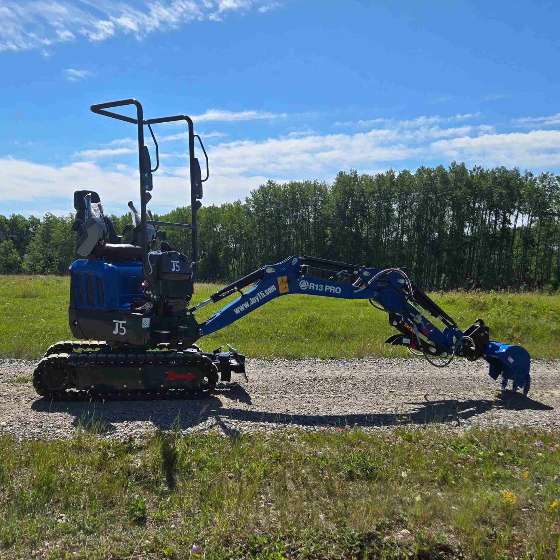 Side profile of Rippa R13 1.3 ton mini excavator with digging arm fully extended on gravel path | Compact mini excavator for construction and landscaping projects in Canada with JoyT5 support