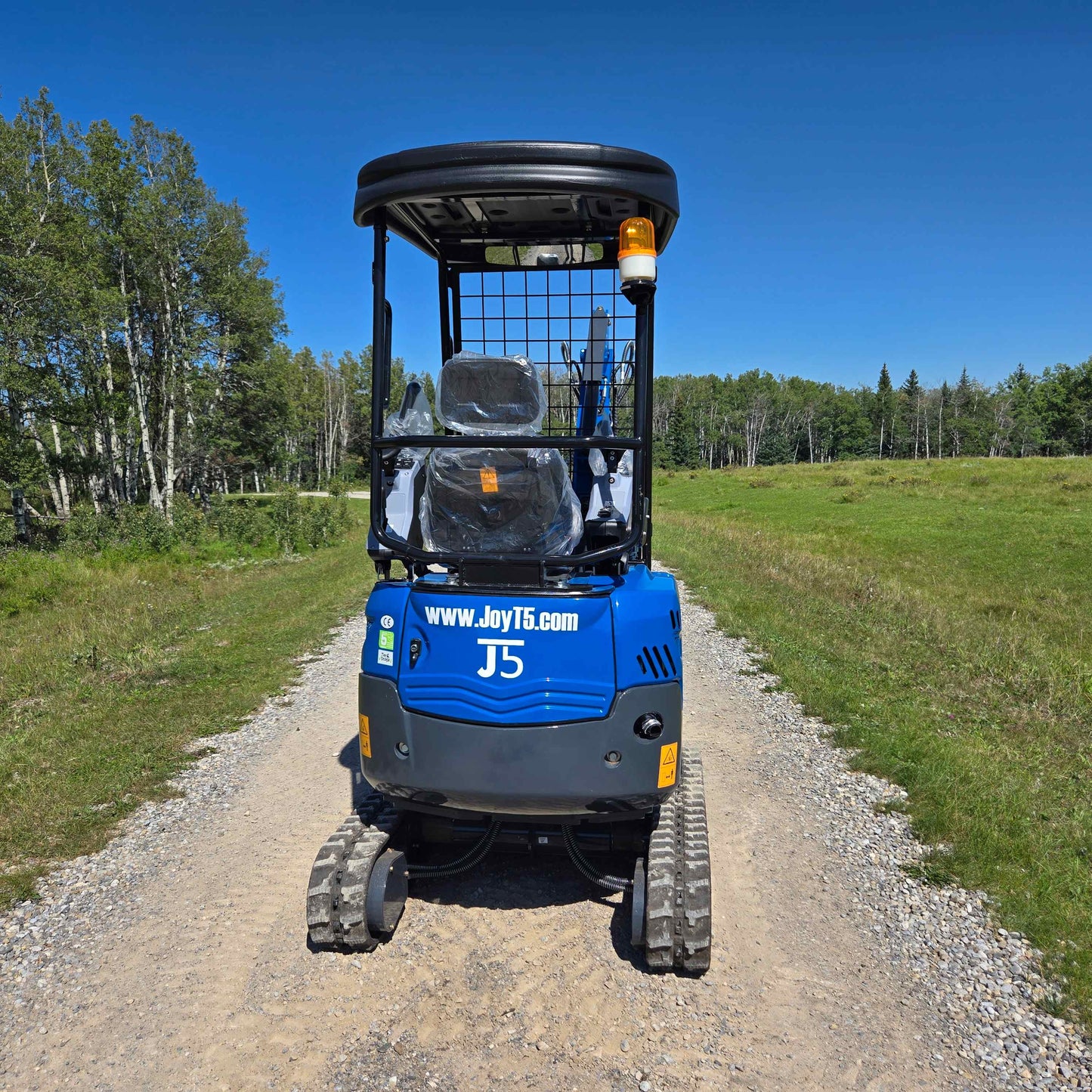 Rippa R15 1.5 Ton Mini Excavator for Sale in Canada rear view of compact digging machine with JoyT5 branding working on a gravel path for landscaping and construction in Canada

