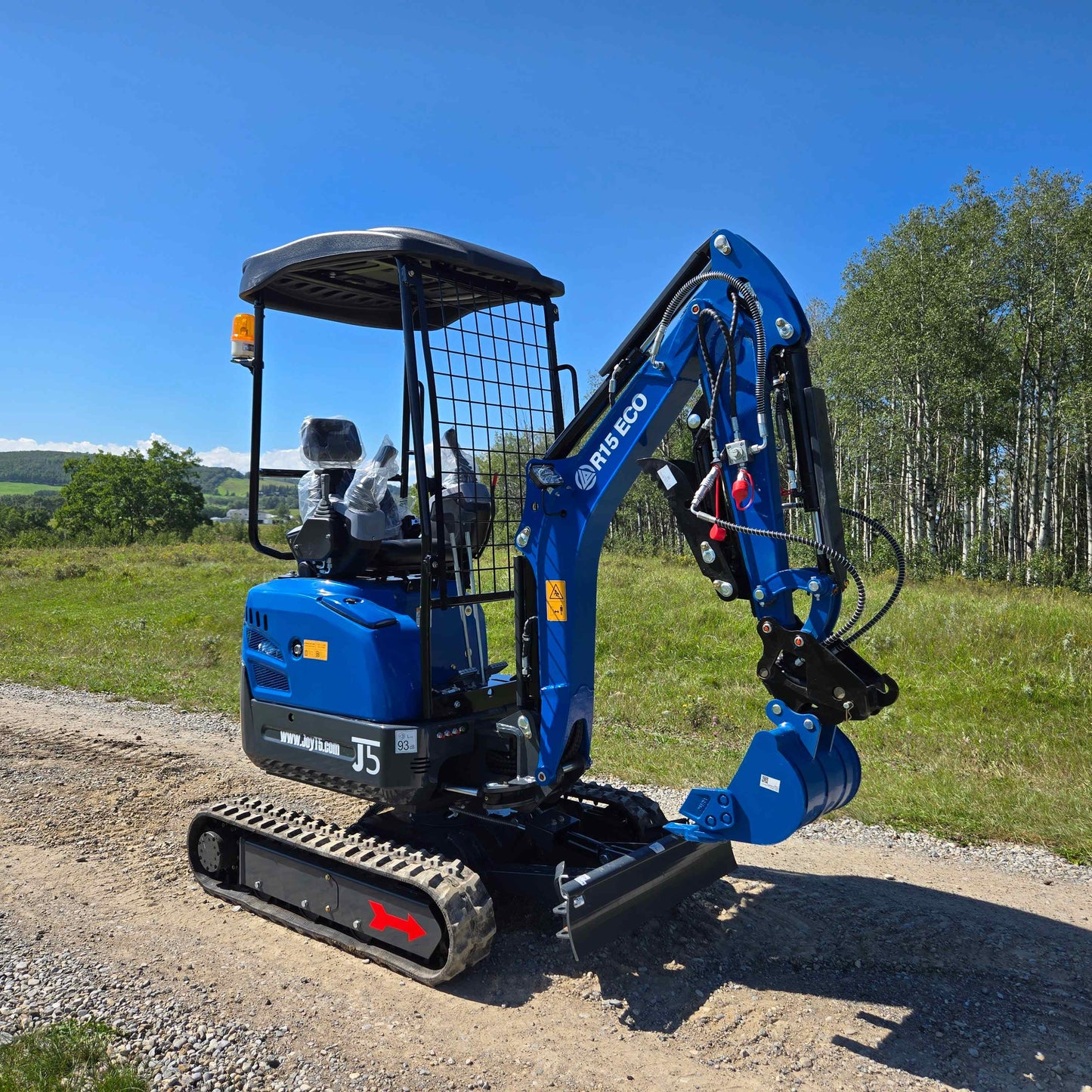 Rippa R15 1.5 ton mini excavator for sale in Canada from JoyT5 shown working on a gravel road small excavator for construction Canada ideal for landscaping and tight spaces

