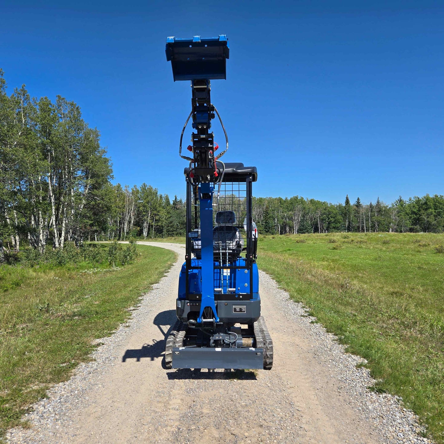 Rippa R15 1.5 ton mini excavator from JoyT5 in Canada with the boom raised on a gravel path for compact construction and landscaping work
