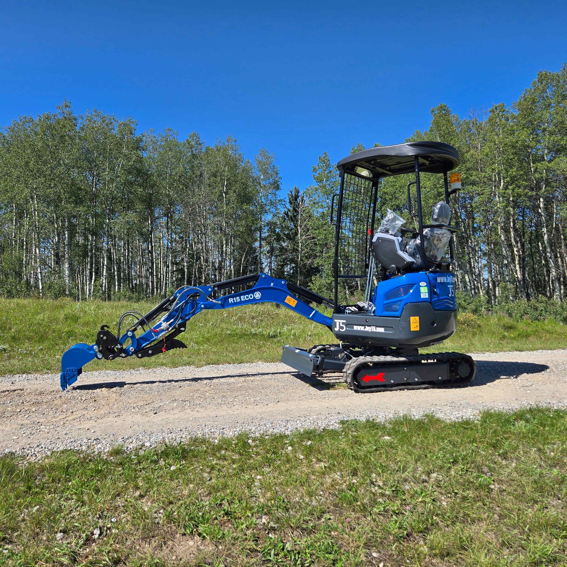 Rippa R15 1.5 ton mini excavator on a gravel road in Canada operated with JoyT5 dealer support for landscaping and construction work