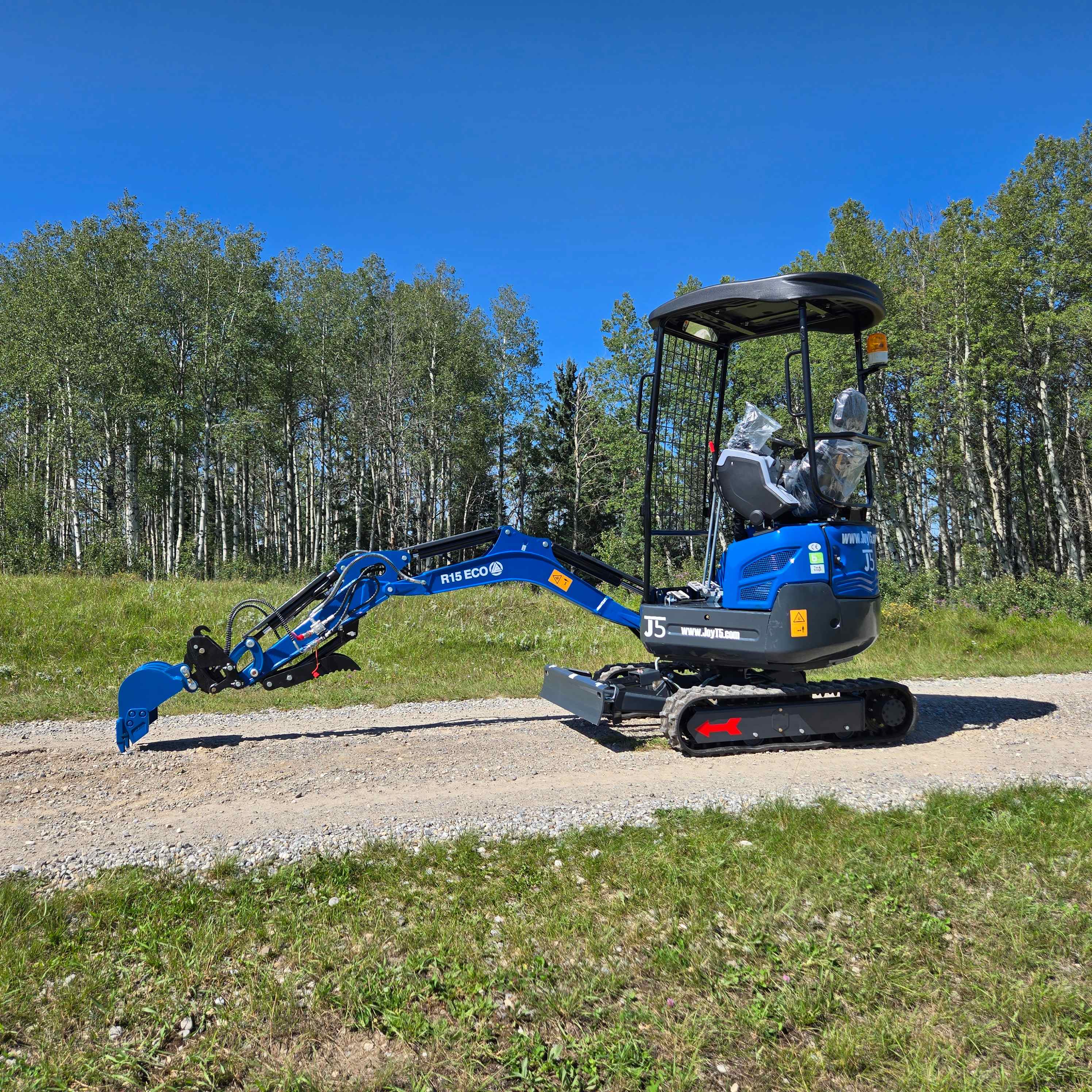 Rippa R15 1.5 ton mini excavator on a gravel road in Canada operated with JoyT5 dealer support for landscaping and construction work