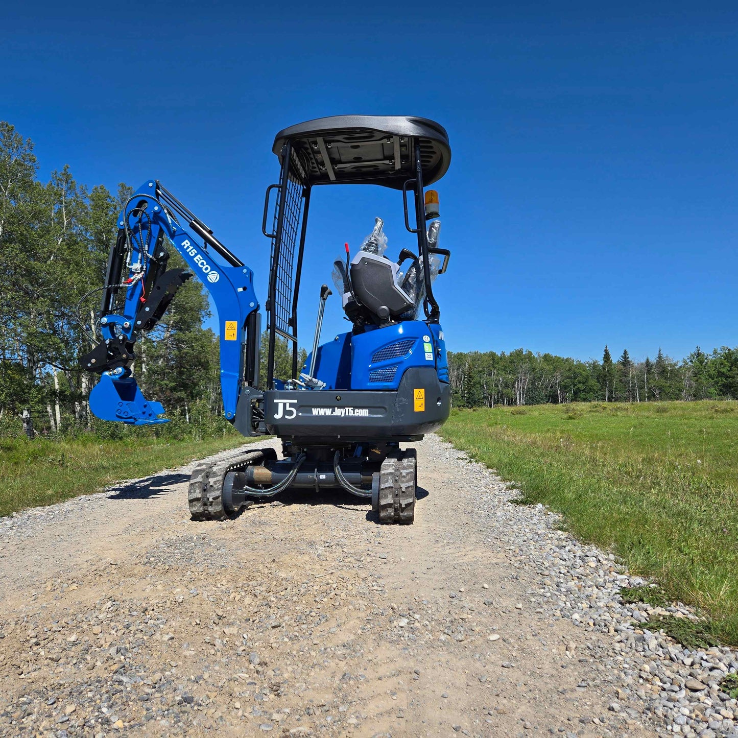 Rippa R15 mini excavator on a gravel road in Canada with JoyT5 dealership support showing compact small digger ready for residential construction and landscaping