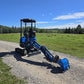 Rippa R15 mini excavator with digging arm extended on gravel road in field