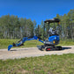 Rippa R15 Mini Excavator For Sale – full side view with extended digging arm and bucket on gravel path.
