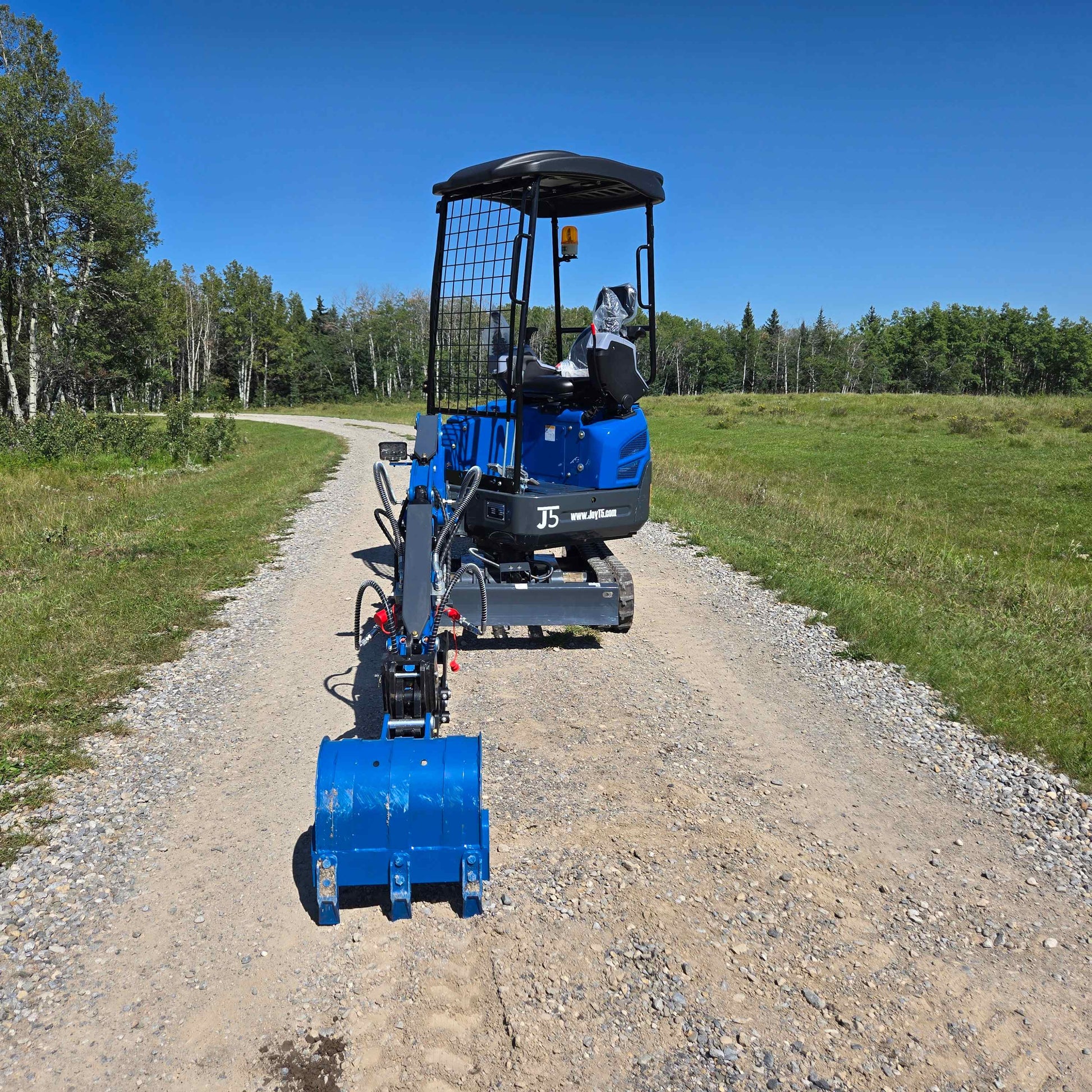 Front view Rippa R15 1.5 ton mini excavator on gravel road in Canada with JoyT5 compact excavator for landscaping and small construction projects
