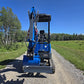 Front view of Rippa R15 mini excavator with digging bucket on gravel road