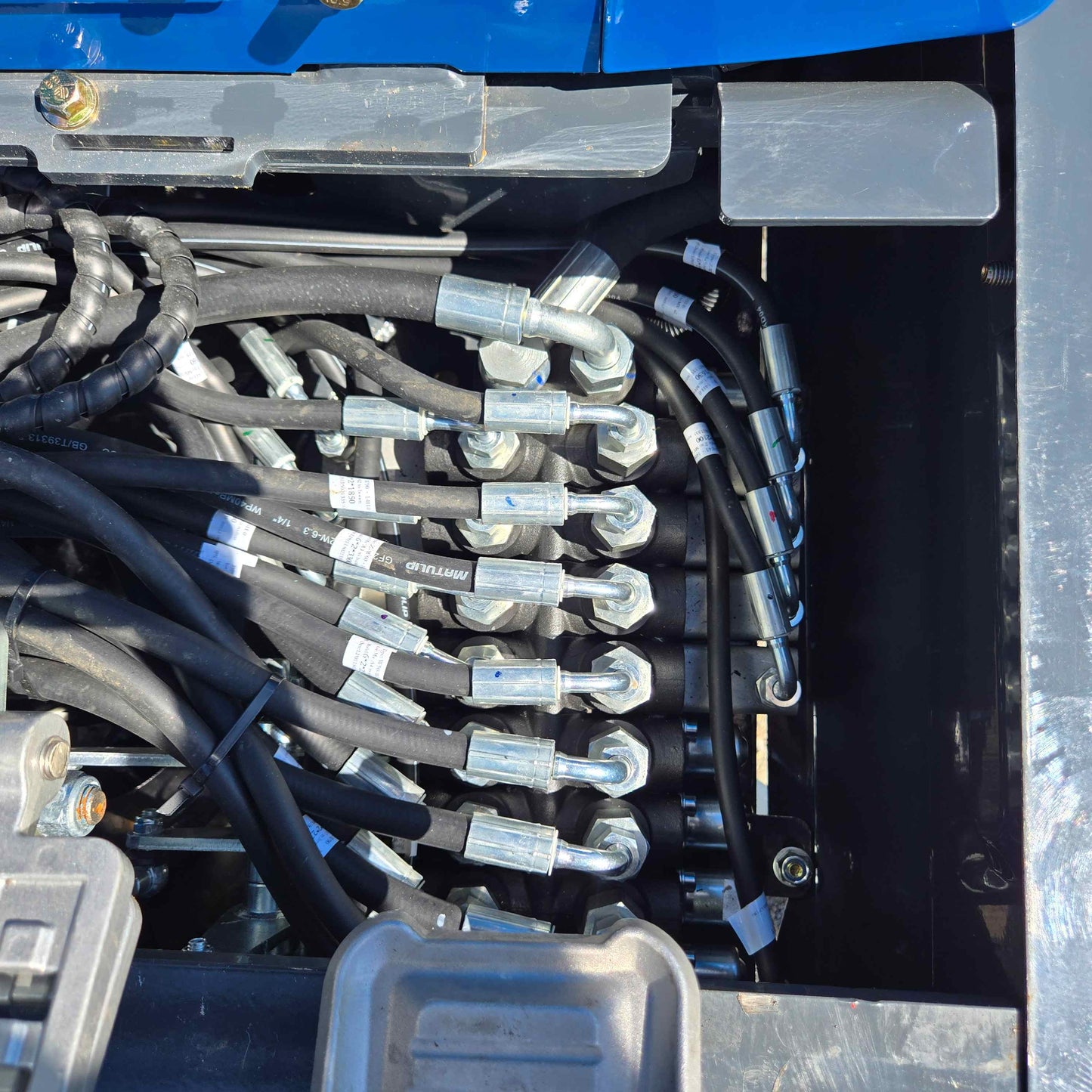 Detailed view of the hydraulic system on the Rippa R15 Mini Excavator, showing durable hose connections and fittings.
