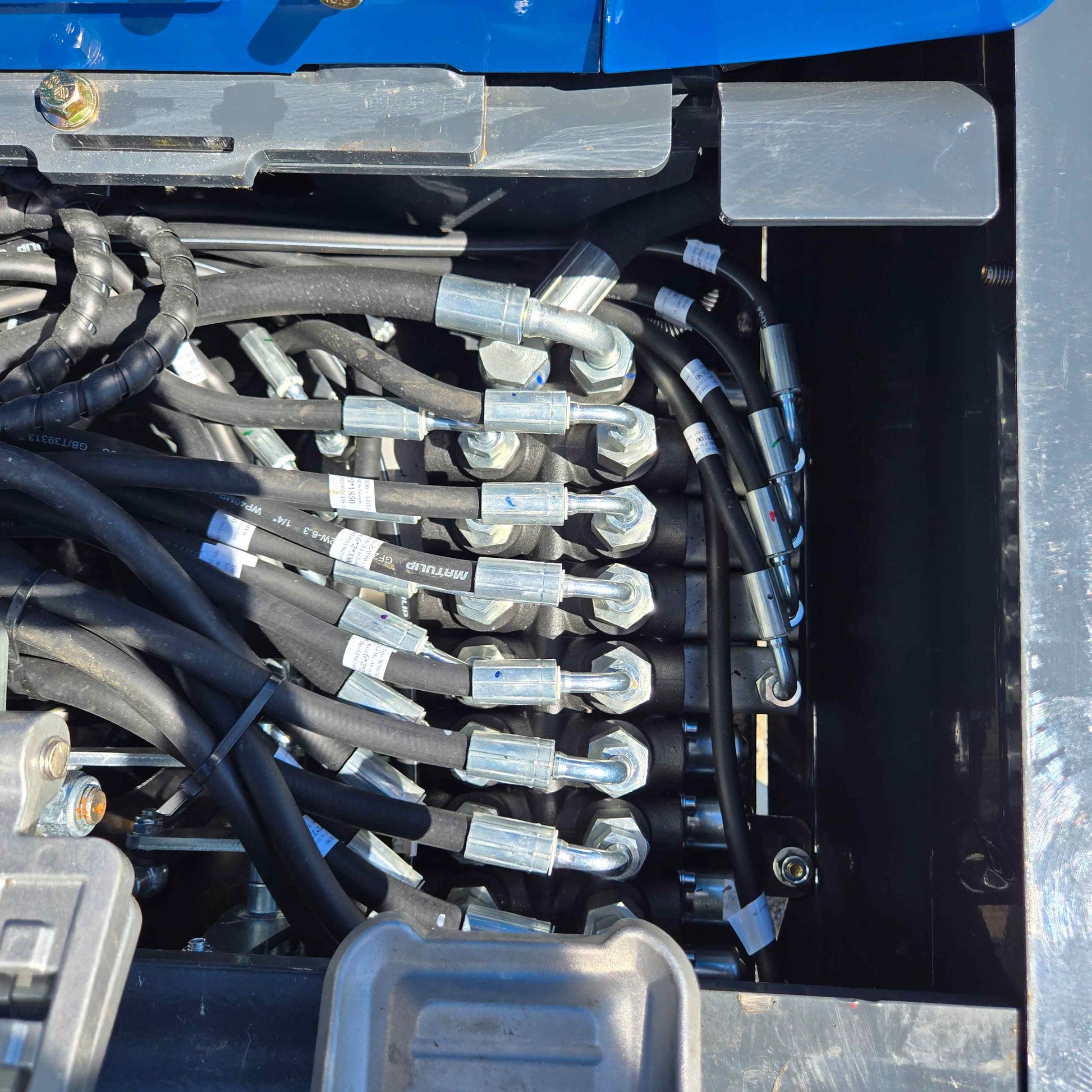 Detailed view of the hydraulic system on the Rippa R15 Mini Excavator, showing durable hose connections and fittings.
