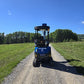 Rippa R15 mini excavator rear view on gravel road in green field