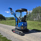 Rippa R15 mini excavator side view on gravel road with raised digging arm