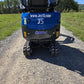 Rear view of Rippa R15 mini excavator on gravel road showing tracks and logo