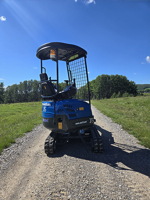  rippa r15 mini excavator for sale,arked on a gravel pathway with green field and blue sky background