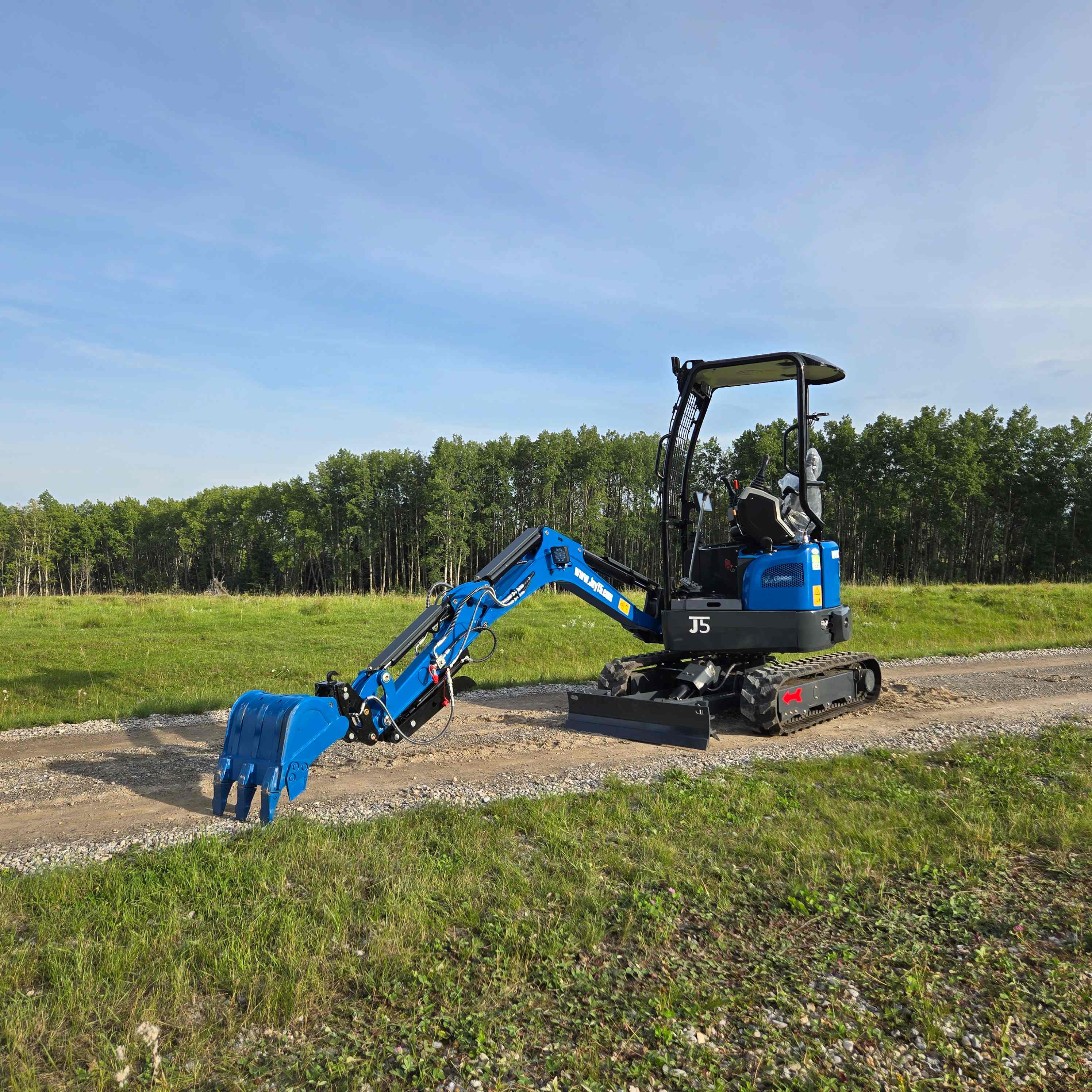 Rippa R18 mini excavator working on a gravel road in Canada JoyT5 compact excavator for landscaping and small construction powered by Kubota D902