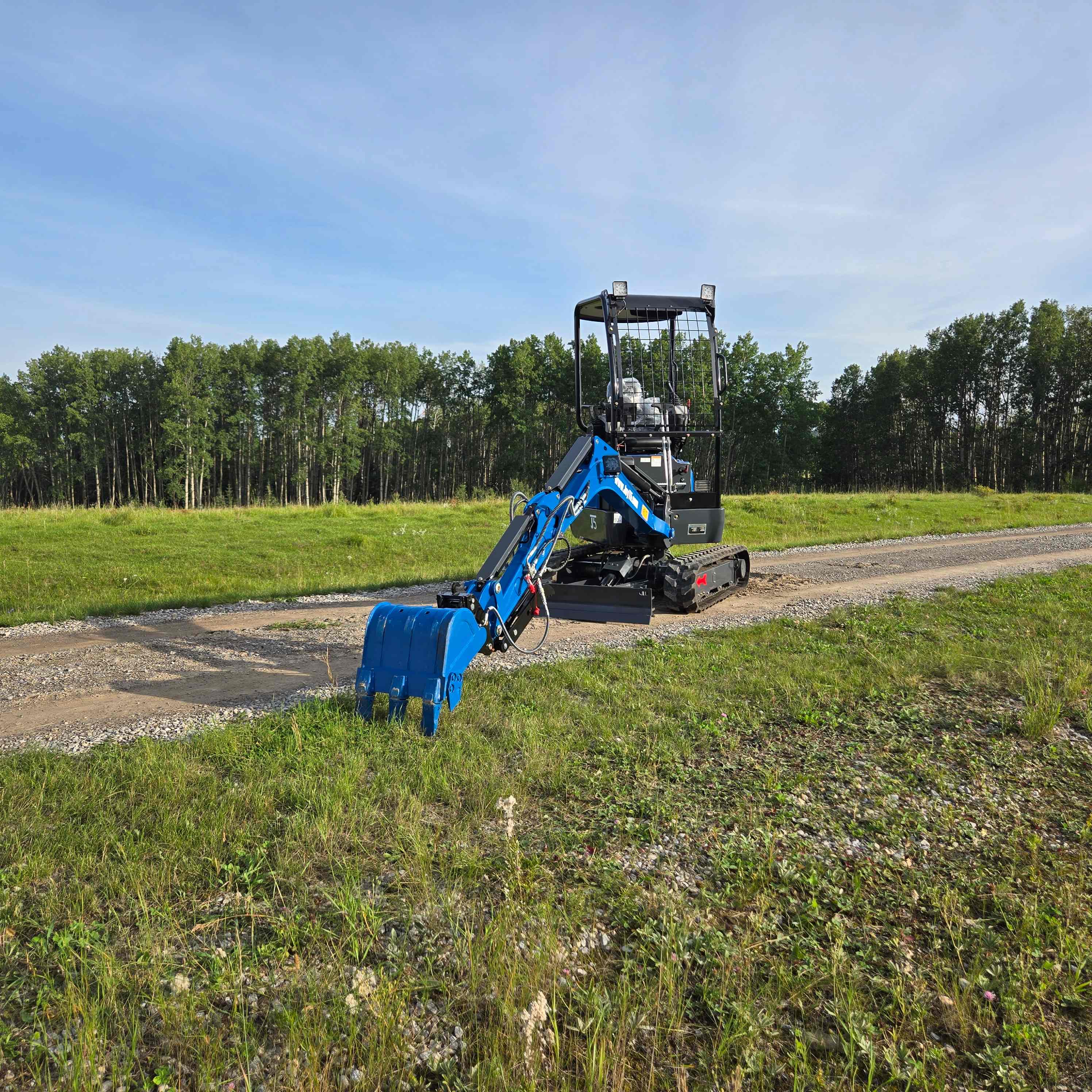 Rippa R18 1.8 ton mini excavator working on grassy field in Canada by JoyT5 compact landscaping equipment with Kubota D902 engine for small construction projects

